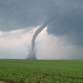 A picture of a small tornado in a field