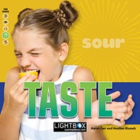 A book cover showing a girl eating a lemon and making a sour face