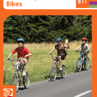 A book cover showing three children riding bicycles on a paved path next to a grassy area with trees.