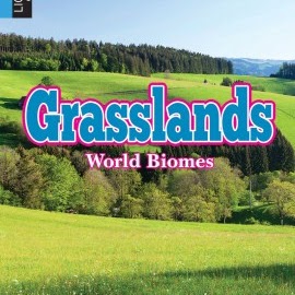 A book cover displays lush green rolling hills and meadows with a dense line of evergreen trees in the background under a blue sky, featuring the word "Grasslands" in large blue and pink letters with "World Biomes" in smaller text below it.