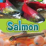 A book cover features two adult red salmon swimming in a river above a green band, with a close-up of developing salmon eggs and a hatched fry below.