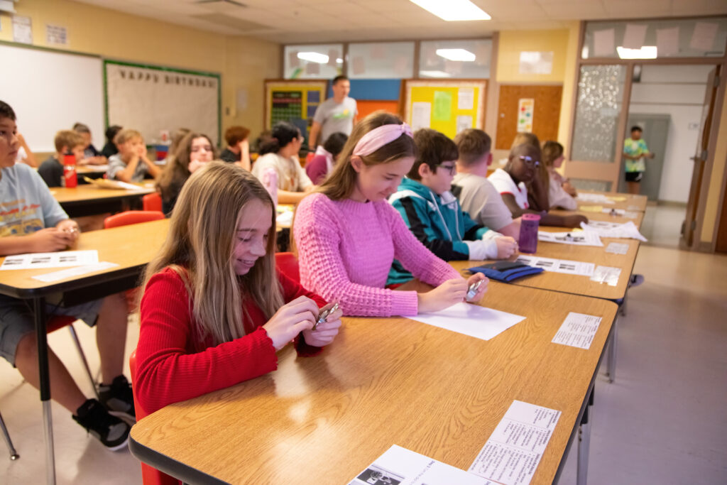 Students at a row of desks working indepedently