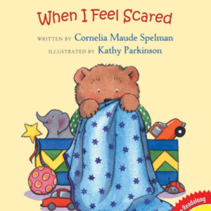 A book cover showing a drawing of a bear who looks scared, hiding behind a blanket with toys scattered around.