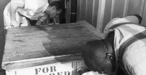 Photo of a water fountain with one side for whites only and one side for colored people only