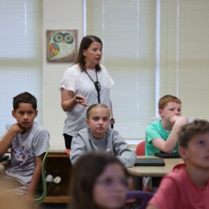 Mrs. Clarke teaching students in the library.