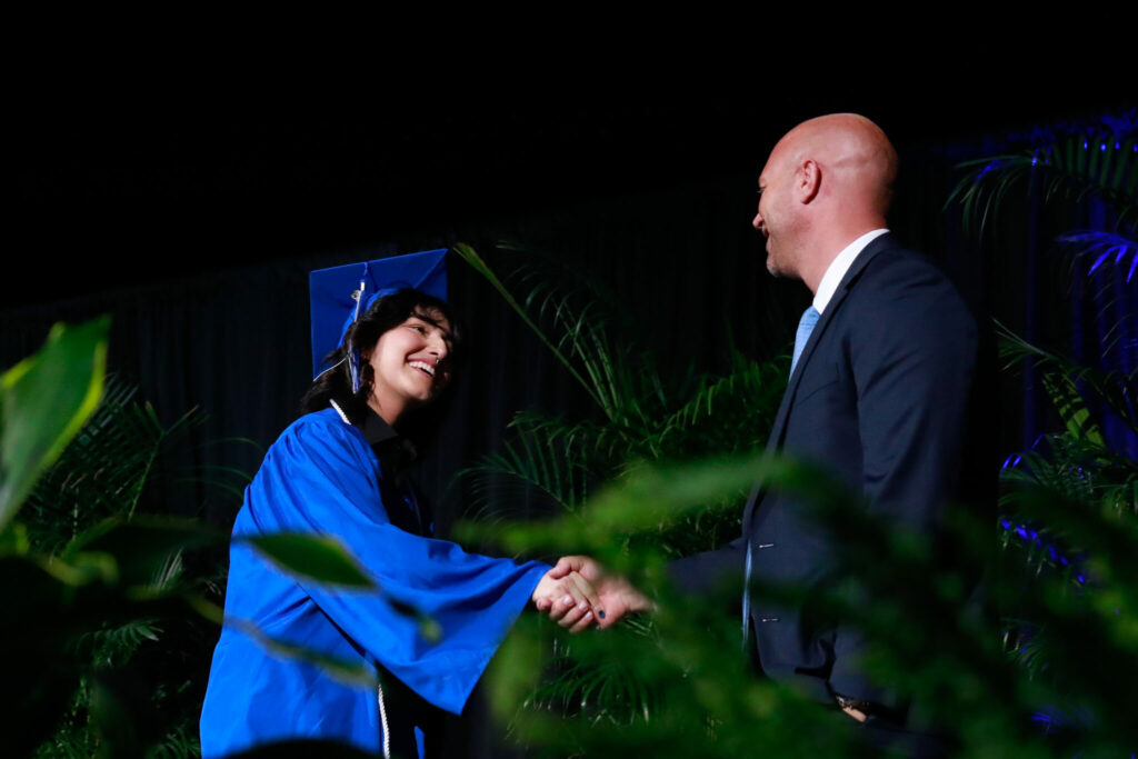 East graduate shaking hands with their principal