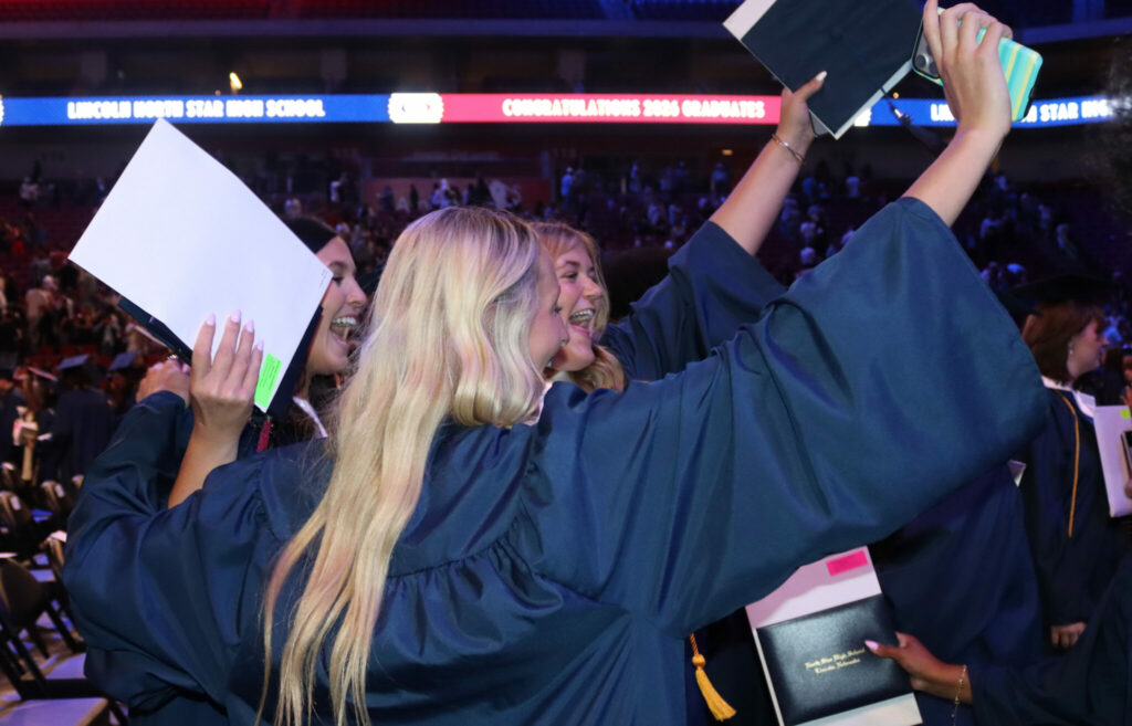 North Star graduates displaying their diplomas