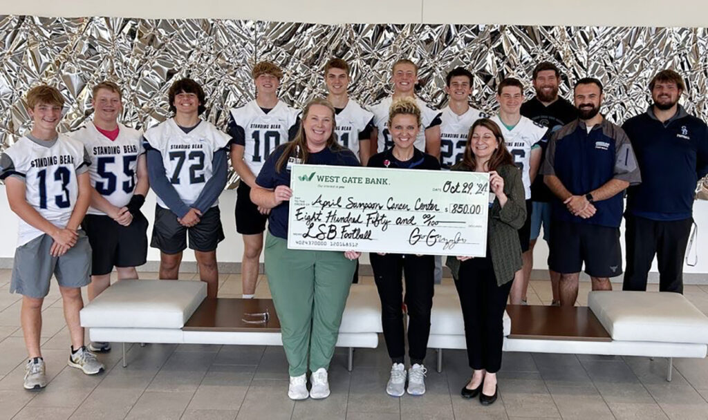 Standing Bear High School football team members raised $850 for Bryan Health's new April Sampson Cancer Center.