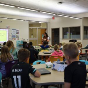 A view of the class listening to instruction in the library.