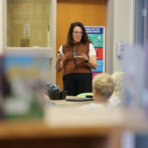 The librarian shares instruction with the class.