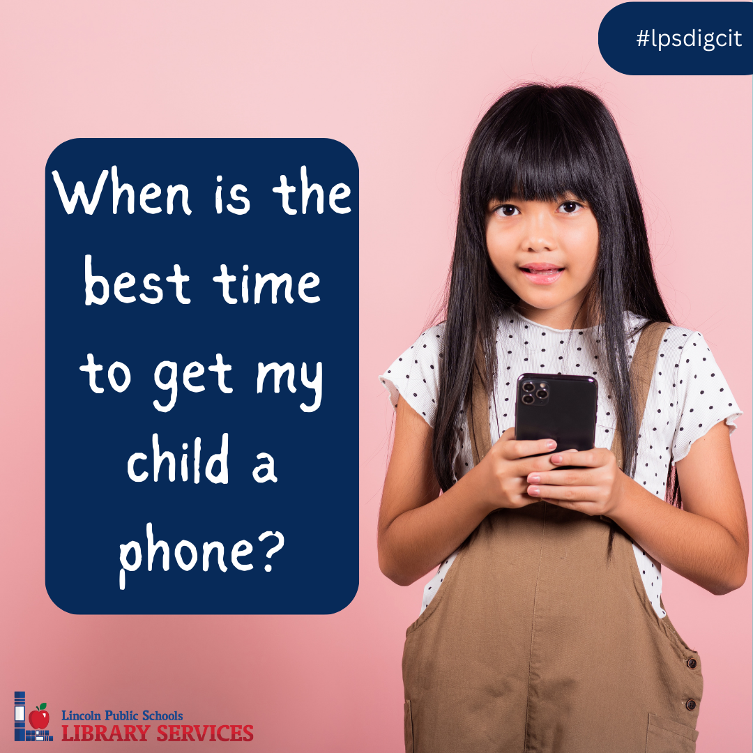 Child holding a cell phone and smiling