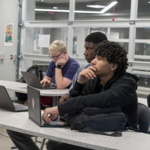 Students listen to instruction in the learning pod.
