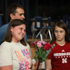 Mrs. Fickes holds flowers while her family looks on.