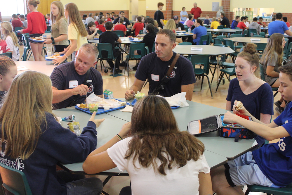 Photo of first responders enjoying lunch with Lux students