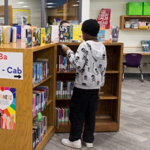 A student explores the fiction collection.