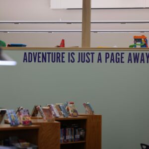 Adventure is a Page Away written on a wall in the library.