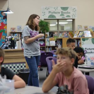 Mrs. Dorcey teaching students in the library.
