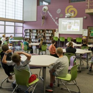 Students listen to instruction in the library.
