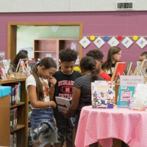 Students browse shelves in the library.