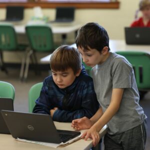 Two students using a Chromebook.