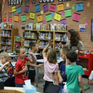 Students walk around the library.