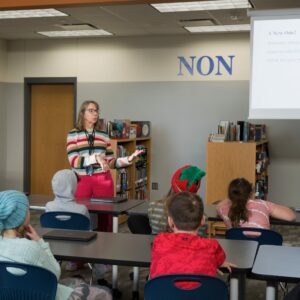 Mrs. Dynek giving instructions in the library.