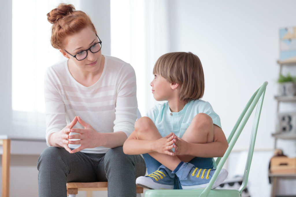 Teacher speaking with student