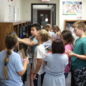 Students look in the nonfiction section for books.
