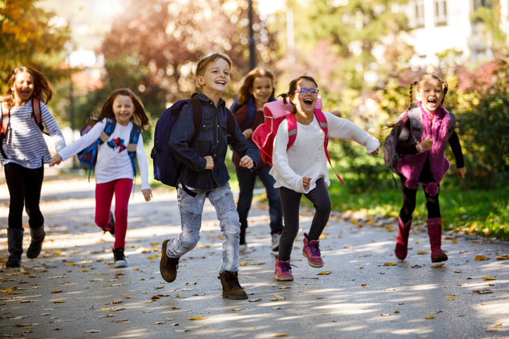 School kids running near a school