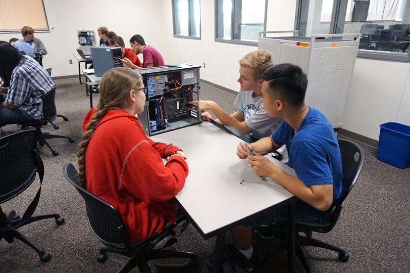 Photo of students working on a computer workstation