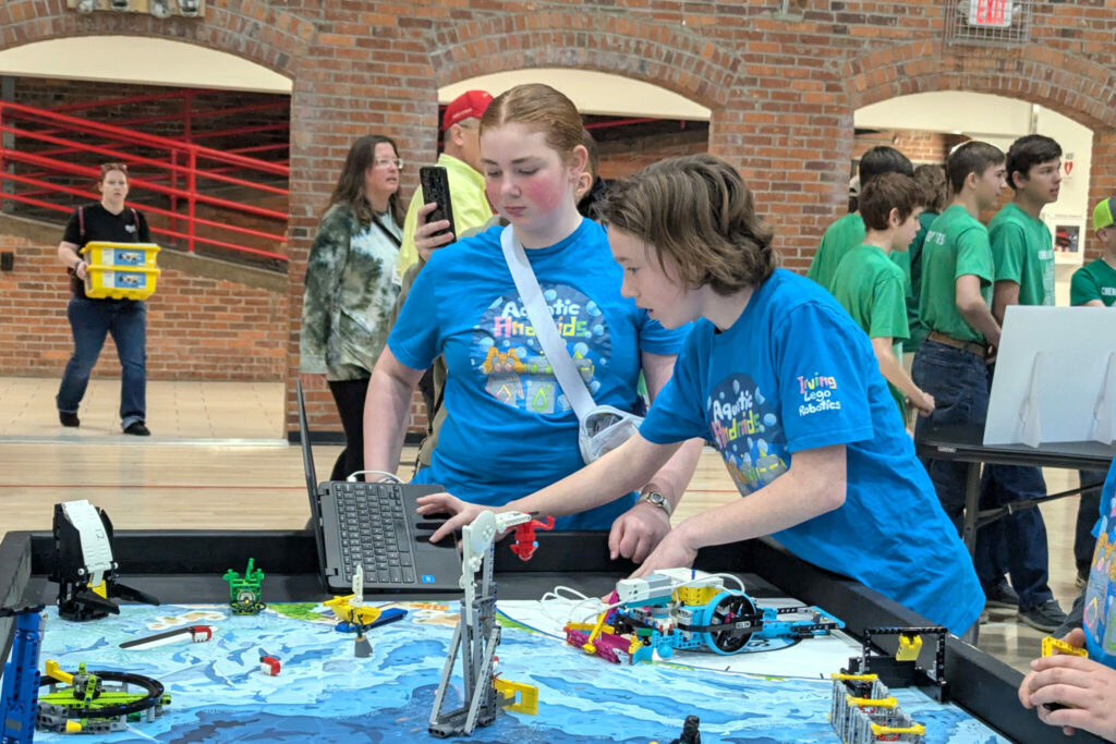 Two members of the Irving Middle School Robotics Club collaborate on a Project at the First Lego League (FLL) Challenge State Championships, held at the University of Nebraska-Lincoln