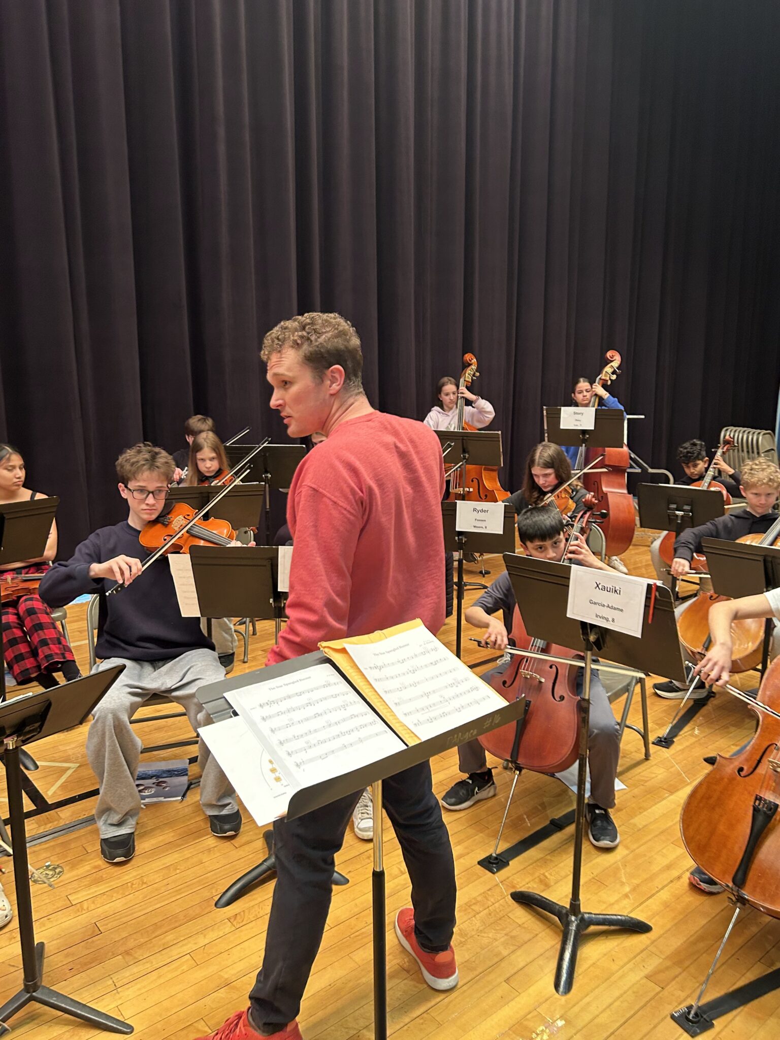 String conductor speaks with his students